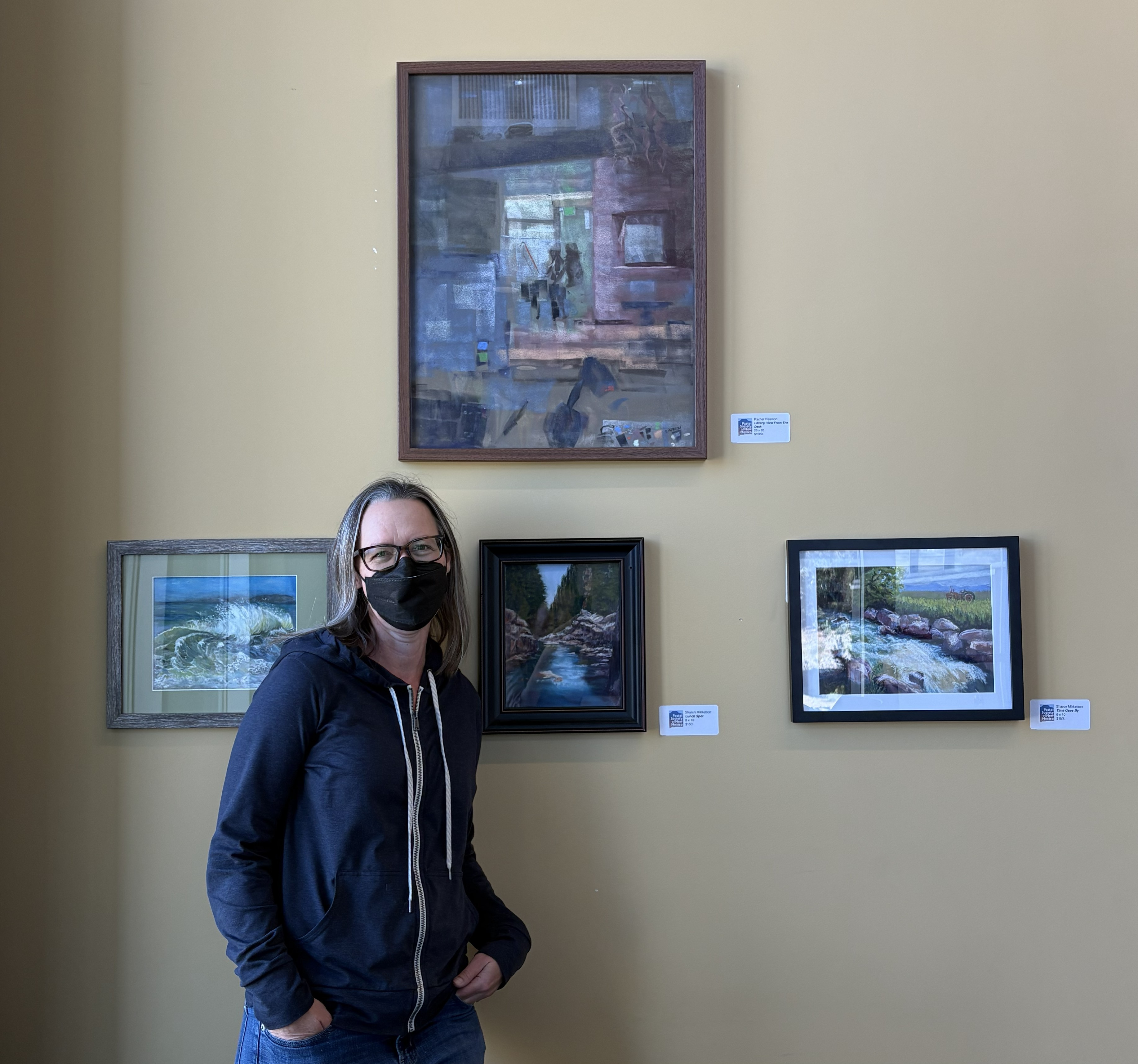 Rachel Pearson standing next to art pieces in White Rock Branch Library